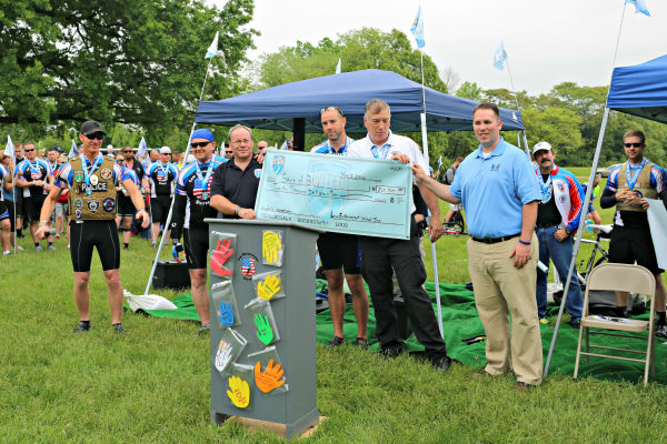 Image Caption – Law Enforcement United (LEU) awarded the Spirit of Blue Foundation $20,000 at their 7th Annual Road to Hope Memorial Ride arrival ceremony. Presenting the donation from LEU was (left to right) Wallace “Chad” Chadwick, Executive Director; Sam Frye, Chaplin; Allan Iverson, Operations Director; Steve Callow, Associate Executive Director; and Mark Faust, Director of Outreach. Receiving the donation was Ryan T. Smith, Executive Director of the Spirit of Blue Foundation.